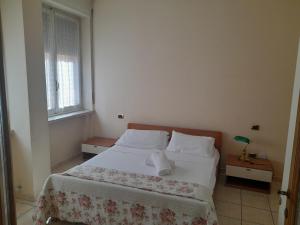a bedroom with a bed with white sheets and a window at Giulietta Apartments City Centre Verona in Verona
