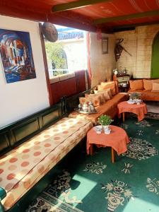 a living room with couches and tables in a room at Dar kenza tunis in Tunis