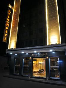 a store front of a hotel at night at Avin Hotel in İzmir