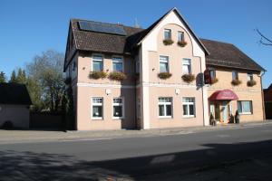 a building with solar panels on it on a street at Buskes Hotel Steinförde in Wietze