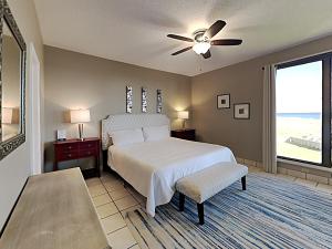 a bedroom with a bed and a ceiling fan at Navarre Towers #203 in Navarre +18 photos