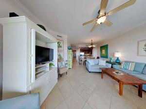 a living room with a blue couch and a tv at Adagio 402D in Santa Rosa Beach