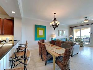 a dining room and living room with a table at Adagio 402D in Santa Rosa Beach