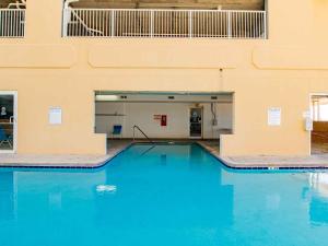 a large swimming pool in a building with blue water at Island Royale Penthouse #405 in Gulf Shores