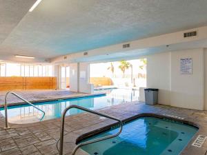 a swimming pool with a hot tub in a building at Island Royale Penthouse #405 in Gulf Shores
