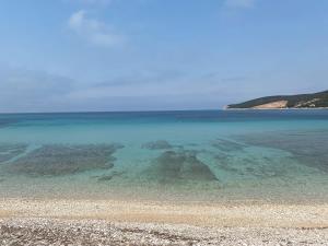 a large body of water with a rocky beach at House Mateja Unije in Unije