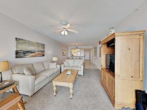 a living room with a couch and a table at The Pearl of Navarre #805 in Navarre