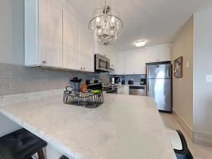 a kitchen with a large marble counter top with a refrigerator at Perdido Skye #32 in Perdido Key