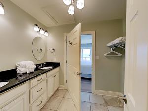 a bathroom with a sink and a mirror at Dory #E in Perdido Key +16 photos