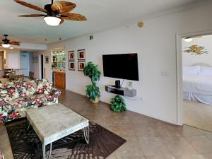 a living room with a couch and a flat screen tv at The Pearl of Navarre #1005 in Navarre