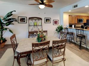 a dining room and kitchen with a table and chairs at The Pearl of Navarre #1005 in Navarre