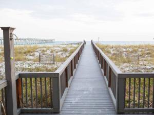 a wooden boardwalk leading to the beach at Summerwinds #204 in Navarre
