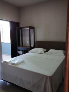 Łóżko lub łóżka w pokoju w obiekcie Canastra Flat Hospedagem