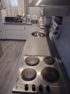 a kitchen with a stove and a sink in it at Mare kuća za odmor in Šibenik