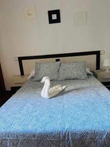 a swan toy sitting on top of a bed at APARTAMENTO HERRERIA in Caldas de Reis
