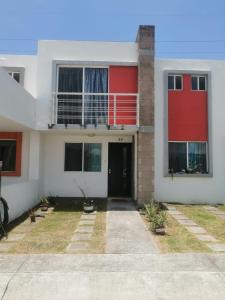 una casa de color rojo y blanco en hermosa casa en coto privado especial para ti y tu familia, en Tepic