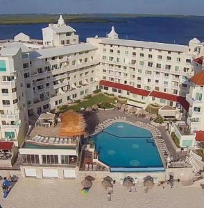 an aerial view of a hotel with a swimming pool at Cancun Plaza Condo Ocean front in Cancún
