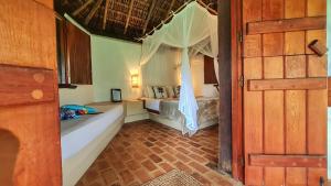 a bedroom with two beds in a room at Aldeia Setemares Bangalôs in Serra Grande