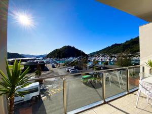 a balcony with a view of a marina at The Moorings Waterfront Picton in Picton