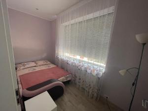A bed or beds in a room at Battonya House