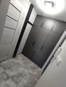 a bathroom with two garage doors and a light at Apartament Heaven in Ełk
