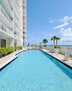 a swimming pool in front of a building at 40th Floor Priceless Unit Central Location in Miami