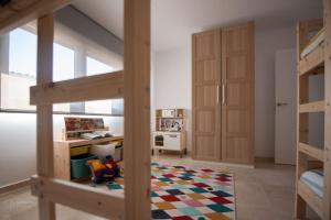 a room with a bunk bed and a bedroom with a desk at Casa Viturna in O Grove +8 photos