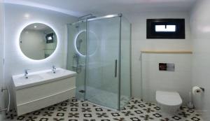 a bathroom with a shower and a sink and a toilet at Casa Viturna in O Grove
