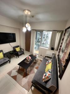 a living room with a couch and a table at Resorts World Condo in Manila