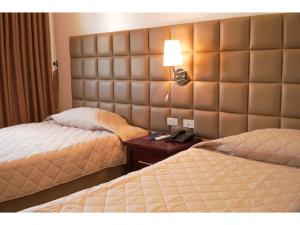 מיטה או מיטות בחדר ב-M28 Hotel and Apartments