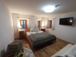 a living room with two beds and a television at Ferienhaus Grabenhansl in Stubenberg +92 photos