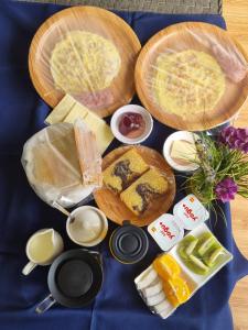 a table with bread and other foods on a blue table cloth at La Digue Luxury Beach Bungalow Spa & Gym in La Digue