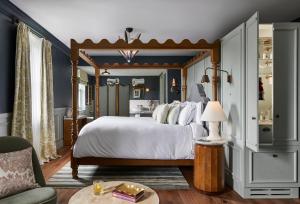a bedroom with a large bed with a wooden frame at Osborn House in Bundanoon +37 photos