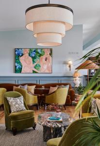 a living room with couches and a large chandelier at Osborn House in Bundanoon