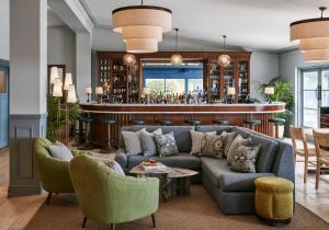 a living room with a couch and chairs and a bar at Osborn House in Bundanoon
