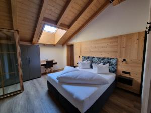 a bedroom with a large white bed in a room at Greidlhof Alpstyle Apartments in Fügen