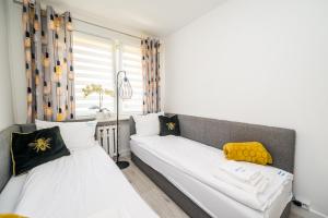 Posteľ alebo postele v izbe v ubytovaní Apartament Natalia
