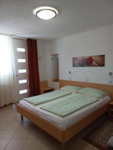 a bedroom with a large bed in a room at Apartments Karmen in Portorož