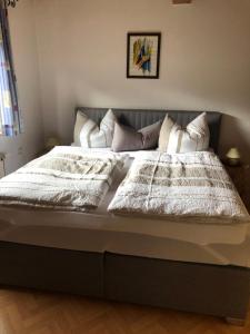 a bed with white blankets and pillows on it at Ferienwohnung im Nationalpark Gesäuse in Hieflau