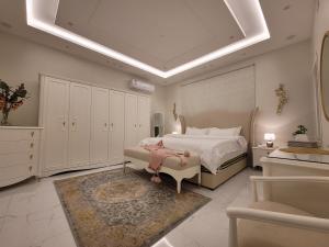 a large bedroom with a bed and a couch at دور واسع وفخم متكامل قرب لافاندا بارك in ‘Aryam