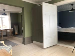 Habitación con dormitorio con cama y puerta en Krepelin Apartments, en Kristinestad