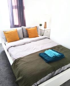 a large bed with two towels on top of it at Sigma Central Apartment 3 in North Shields