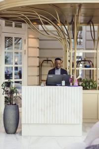 a man sitting at a desk with a laptop at Villa Copenhagen in Copenhagen +69 photos