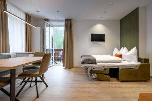 a hotel room with a bed and a dining table at Villa Fauster Pustrabase in Villabassa