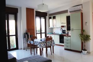 a kitchen and dining room with a table and chairs at B&B Lidia Apartaments in Termoli +13 photos
