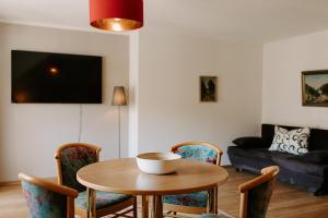 a living room with a table and chairs and a couch at Hotel Linde Durbach in Durbach