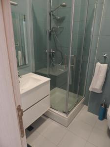 a bathroom with a glass shower and a sink at Apartments Lori in Biograd na Moru