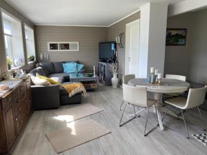 a living room with a couch and a table at Lyngen, Mackay appartment, Lyngen in Lyngseidet