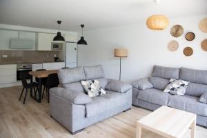 a living room with a couch and a table at Jamaica Beach House in Puebla de Farnals