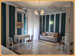 a living room with a couch and a table and chairs at Chez Tata' - Scé Tatà in Rossano Stazione